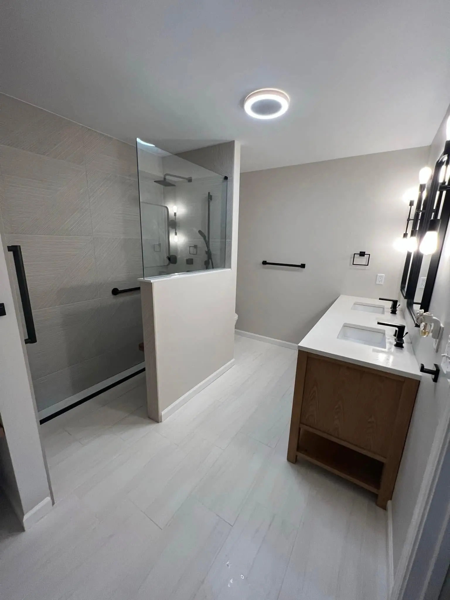 After: Custom bathroom remodel with updated tile, vanity, and fixtures