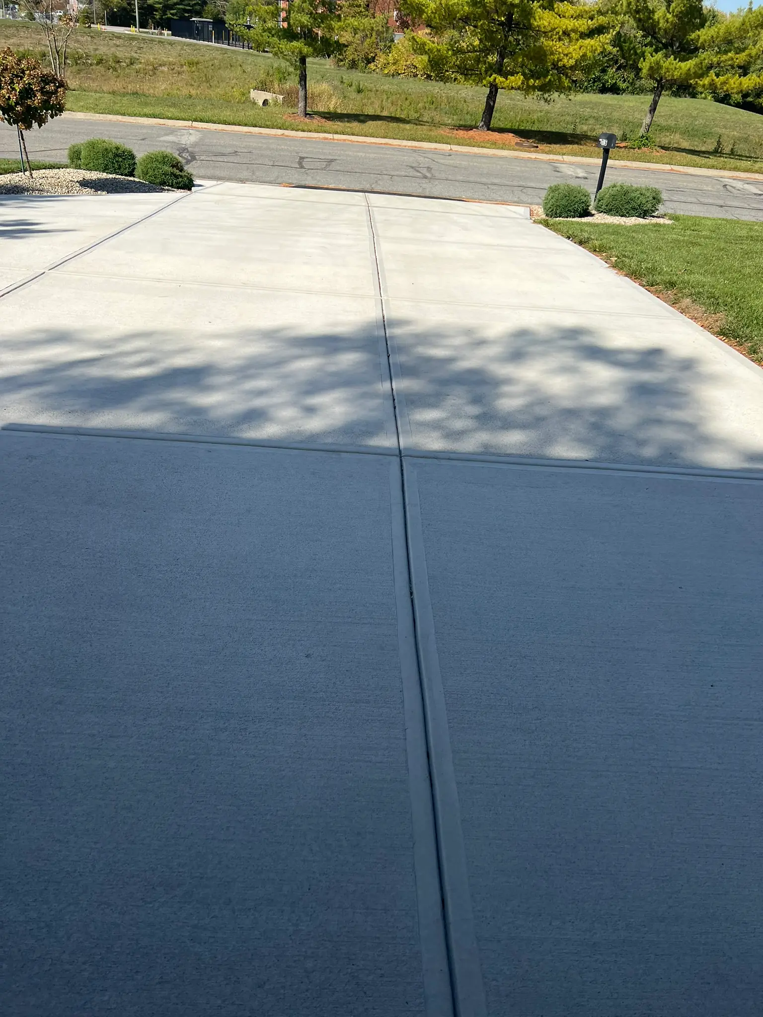 Concrete driveway showing clean expansion joint and two-tone finish